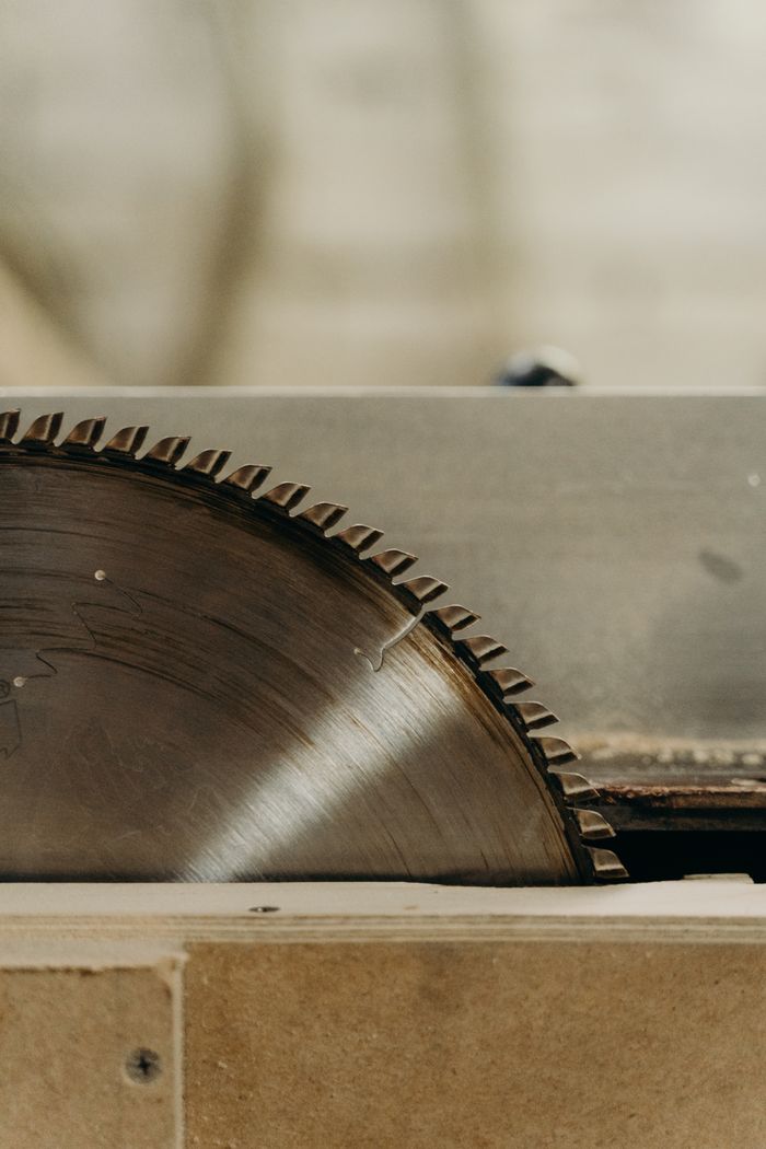 Detailed image of a sharp circular saw blade in use, ideal for industrial themes.
